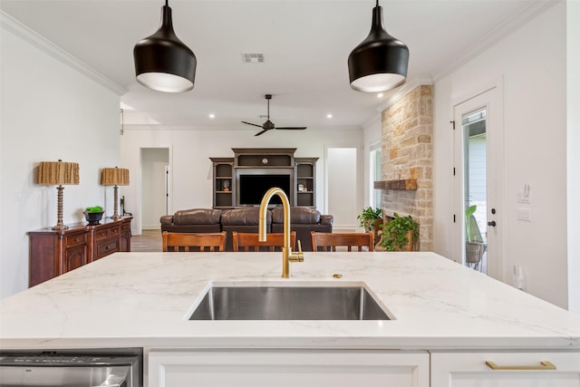 10136 Braided Briar Ln, Waco, TX 76712 - kitchen featuring a sink, stainless steel dishwasher, open floor plan, light stone countertops, and a ceiling fan