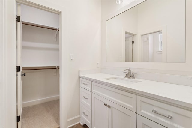10136 Braided Briar Ln, Waco, TX 76712 - bathroom featuring vanity, a spacious closet, and baseboards