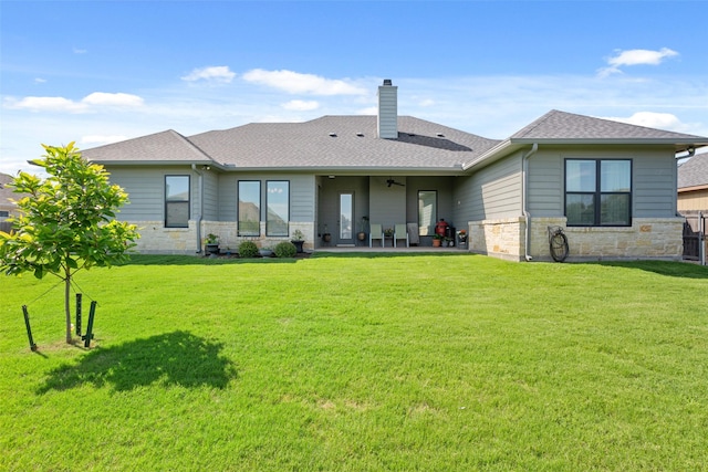 10136 Braided Briar Ln, Waco, TX 76712 - back of house with stone siding, a patio, a chimney, and a lawn
