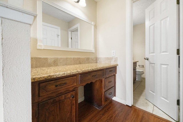 908 Cherry Laurel Ln, Arlington, TX 76012 - bathroom with toilet, vanity, a textured ceiling, and tile patterned floors