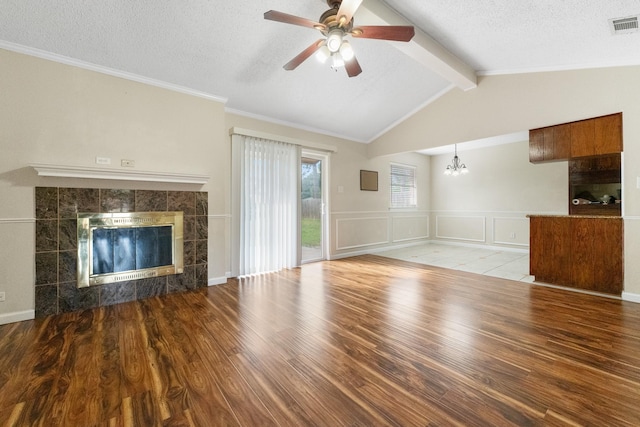908 Cherry Laurel Ln, Arlington, TX 76012 - unfurnished living room with a tiled fireplace, wood finished floors, a chandelier, a ceiling fan, and a textured ceiling