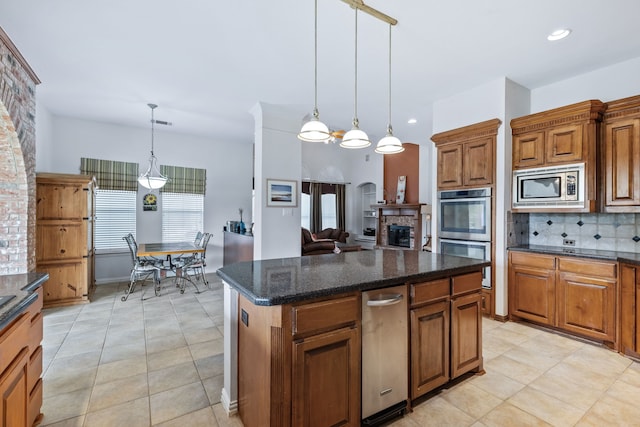 420 Bee Caves Rd, Lucas, TX 75002 - kitchen featuring appliances with stainless steel finishes, brown cabinetry, healthy amount of natural light, backsplash, and recessed lighting