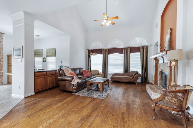 420 Bee Caves Rd, Lucas, TX 75002 - living area featuring high vaulted ceiling, a ceiling fan, healthy amount of natural light, a brick fireplace, and decorative columns
