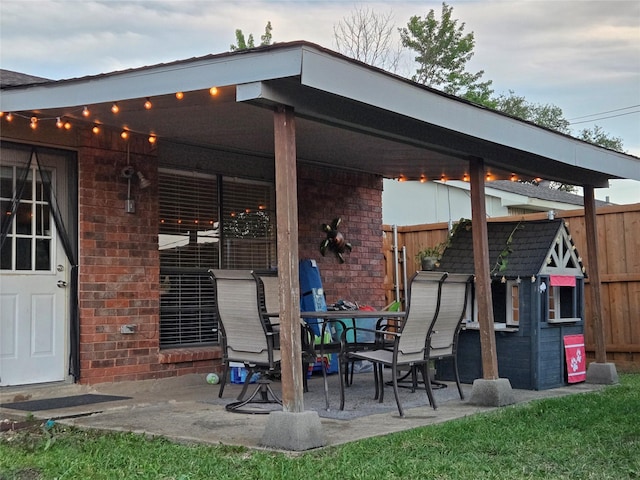 view of patio featuring fence and outdoor dining area