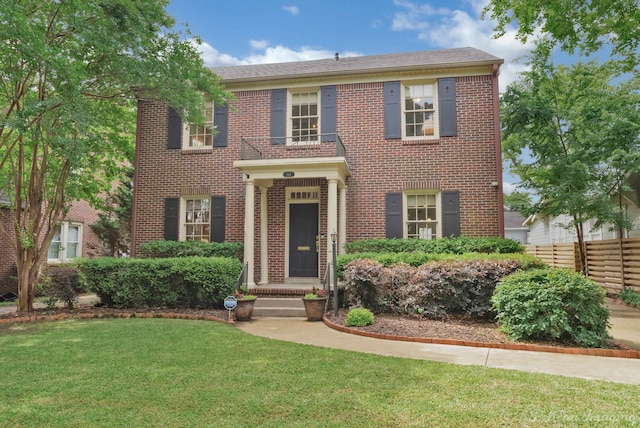 colonial inspired home with brick siding