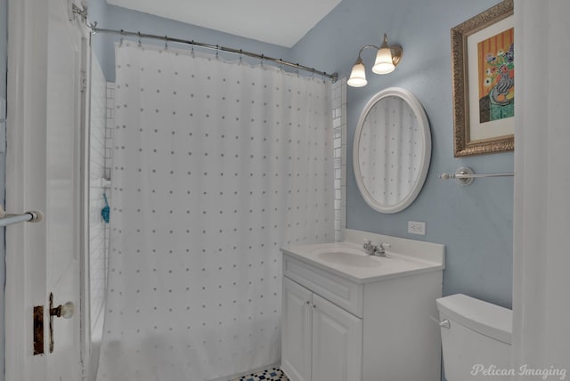 bathroom with toilet, vanity, and a shower with curtain