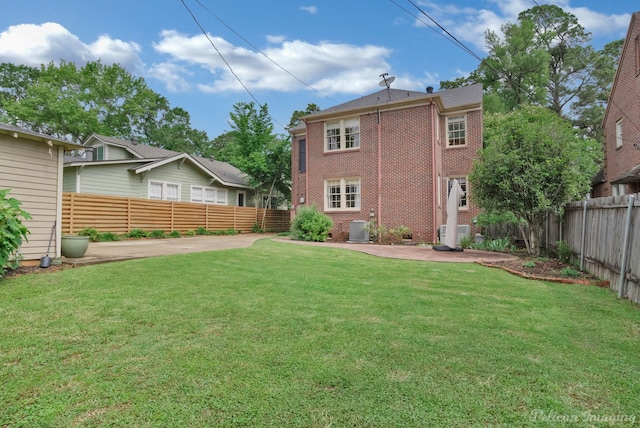 rear view of property featuring cooling unit, a patio, and brick siding