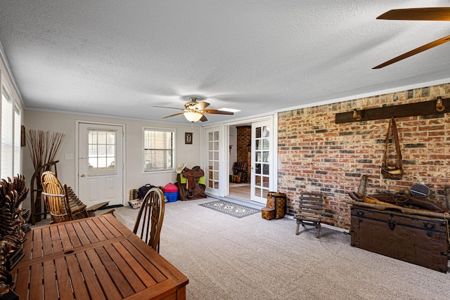 818 Country Club Rd, Bowie, TX 76230 - dining room with a ceiling fan, a textured ceiling, carpet flooring, brick wall, and crown molding