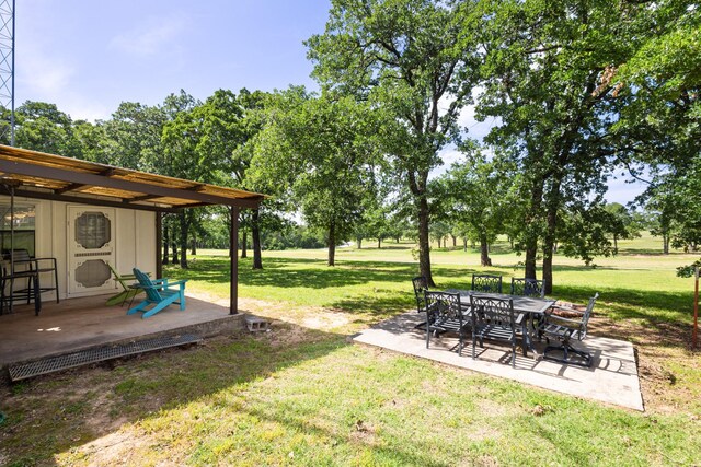 818 Country Club Rd, Bowie, TX 76230 - view of green lawn with a patio