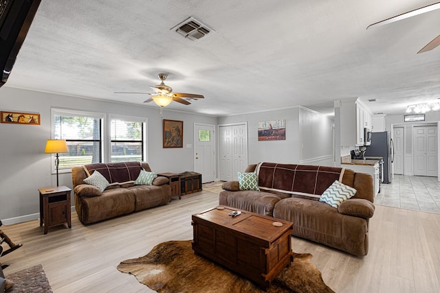 818 Country Club Rd, Bowie, TX 76230 - living room with a ceiling fan, light wood finished floors, and baseboards