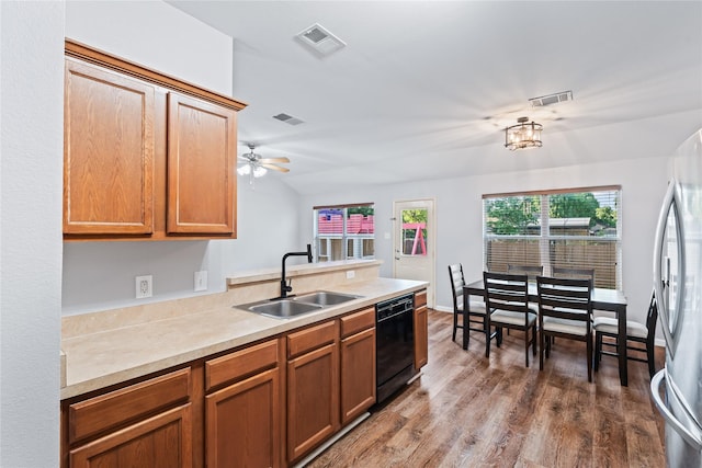 2813 Dana Ln, Denton, TX 76209 - kitchen with a sink, black dishwasher, freestanding refrigerator, wood finished floors, and light countertops