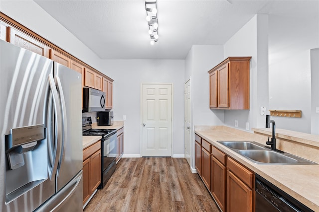 2813 Dana Ln, Denton, TX 76209 - kitchen featuring black appliances, a sink, light countertops, and dark wood-type flooring