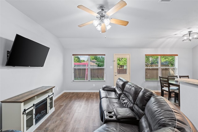2813 Dana Ln, Denton, TX 76209 - living room with wood finished floors, plenty of natural light, ceiling fan, baseboards, and vaulted ceiling