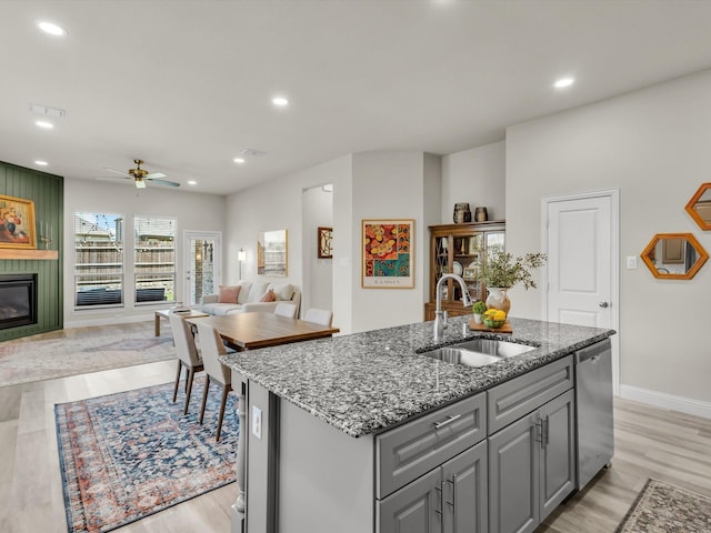 571 Mckenna Dr, Fate, TX 75087 - kitchen with a sink, gray cabinetry, stainless steel dishwasher, light wood finished floors, and recessed lighting