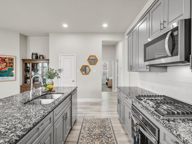 571 Mckenna Dr, Fate, TX 75087 - kitchen featuring gray cabinets, stainless steel appliances, a kitchen island with sink, recessed lighting, and light stone countertops