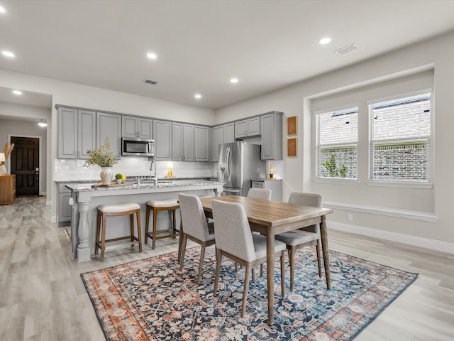 571 Mckenna Dr, Fate, TX 75087 - dining room featuring light wood-type flooring, recessed lighting, and baseboards