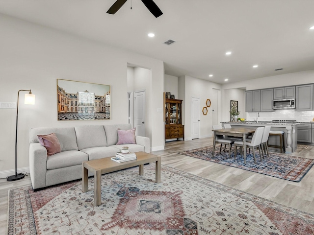 571 Mckenna Dr, Fate, TX 75087 - living room with light wood-style flooring, ceiling fan, baseboards, and recessed lighting