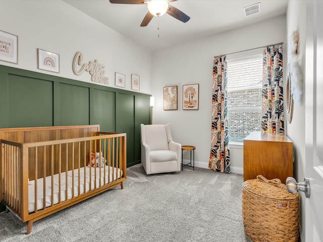 571 Mckenna Dr, Fate, TX 75087 - carpeted bedroom featuring a nursery area, a ceiling fan, and a decorative wall