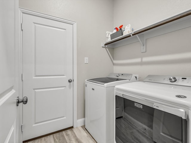 571 Mckenna Dr, Fate, TX 75087 - laundry area featuring washing machine and dryer and light wood-style flooring
