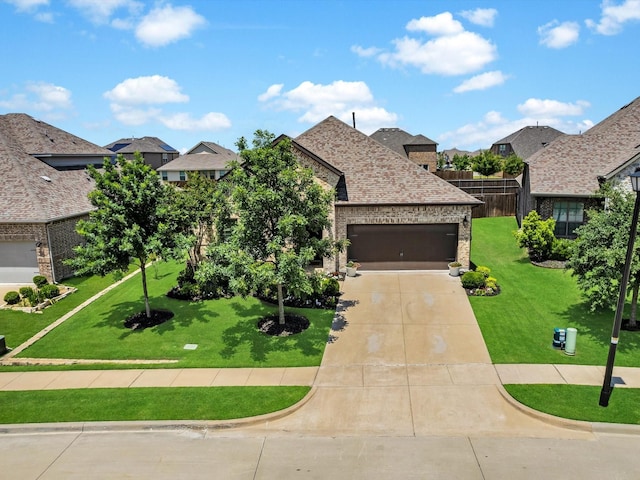 571 Mckenna Dr, Fate, TX 75087 - french country home with a garage, concrete driveway, a residential view, and brick siding