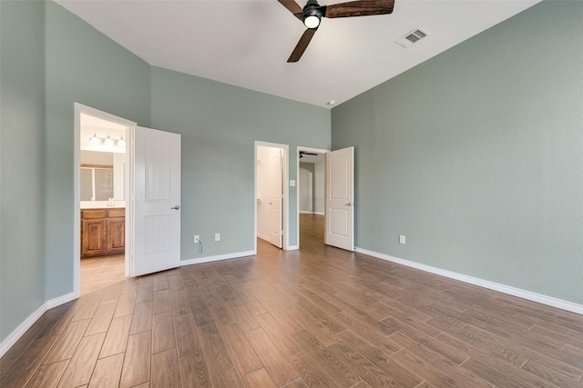 712 Britain Way, Wylie, TX 75098 - unfurnished bedroom with a towering ceiling, dark wood finished floors, baseboards, ensuite bathroom, and a ceiling fan