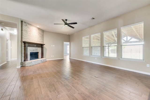 712 Britain Way, Wylie, TX 75098 - unfurnished living room featuring ceiling fan, wood finished floors, a fireplace, and baseboards