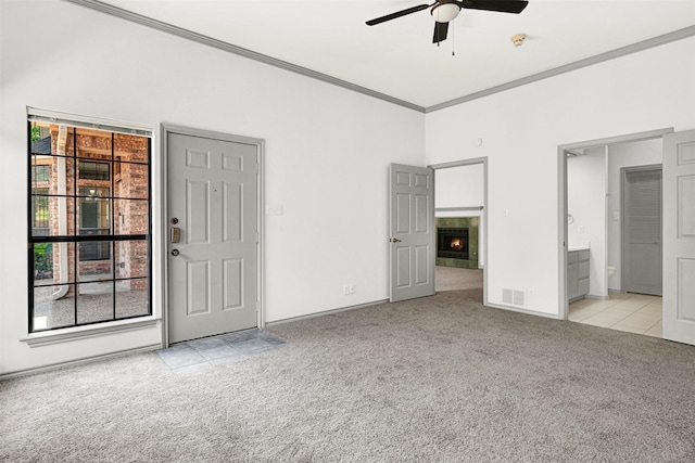 1407 W Mulberry St, Sherman, TX 75092 - unfurnished bedroom with light carpet, multiple windows, crown molding, connected bathroom, and a warm lit fireplace