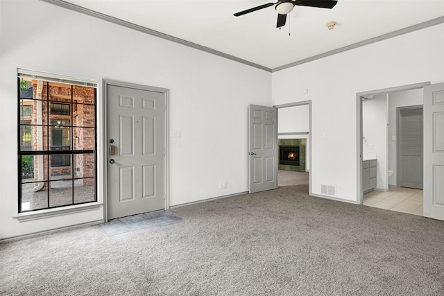 1407 W Mulberry St, Sherman, TX 75092 - unfurnished bedroom featuring light colored carpet, ornamental molding, ensuite bathroom, a tiled fireplace, and baseboards