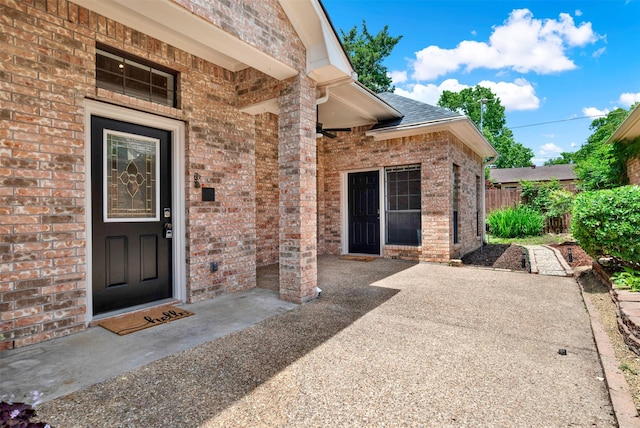 1407 W Mulberry St, Sherman, TX 75092 - doorway to property featuring brick siding, fence, and a shingled roof