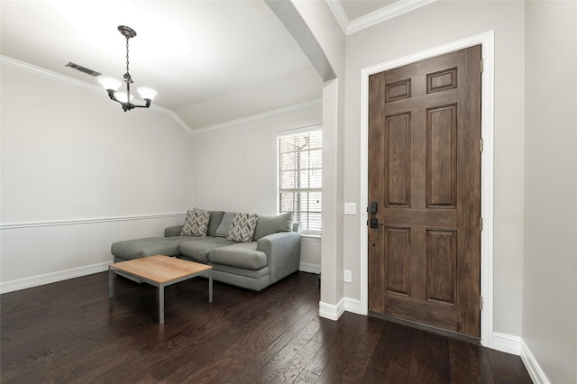 4416 Berry Ridge Ln, Frisco, TX 75036 - foyer featuring crown molding, a chandelier, dark wood-style floors, arched walkways, and baseboards