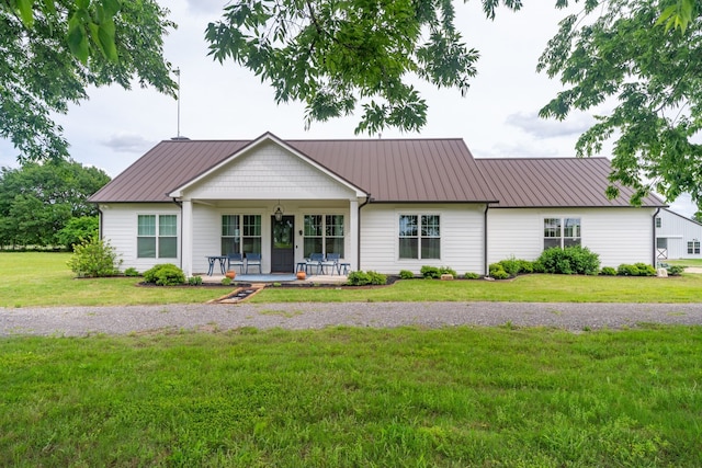 6170 Green Meadow Ln, Terrell, TX 75160 - ranch-style home with covered porch, a front lawn, and metal roof
