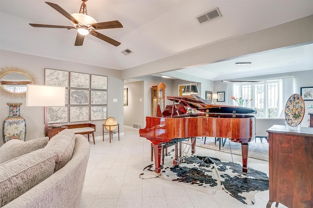 living area featuring a ceiling fan, baseboards, and vaulted ceiling