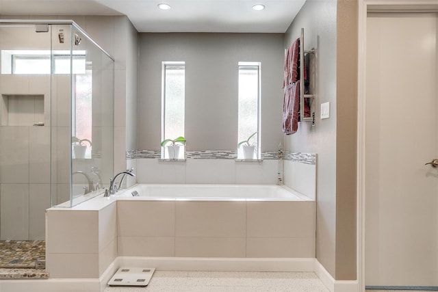 bathroom featuring a stall shower, a bath, and recessed lighting