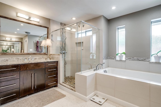 bathroom with a shower stall, vanity, recessed lighting, and a bath