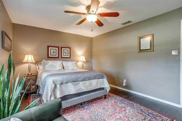 bedroom featuring dark wood-style floors, baseboards, and a ceiling fan