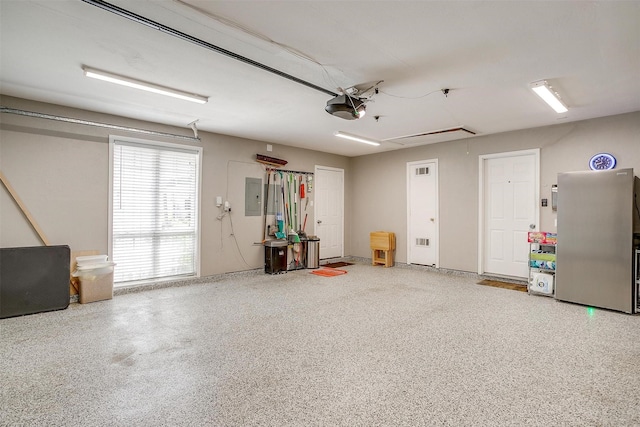 garage with a garage door opener and electric panel