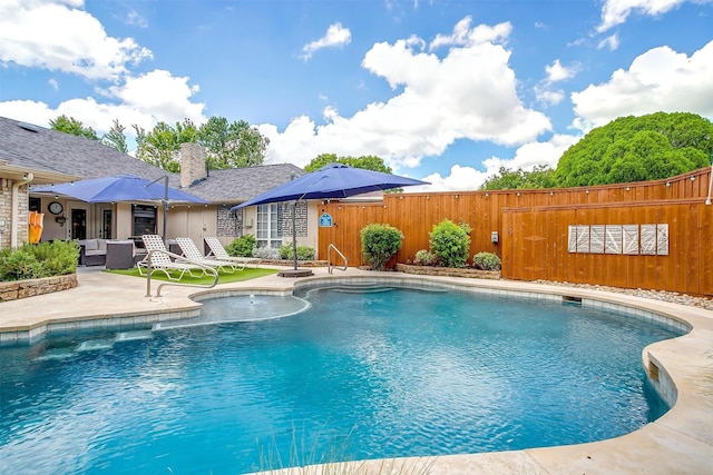 view of swimming pool with fence, a patio, and outdoor lounge area