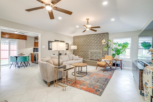 living area with a ceiling fan, plenty of natural light, wine cooler, recessed lighting, and baseboards