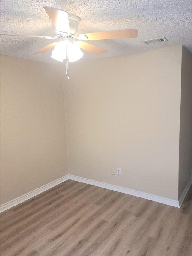 327 Trevino Trl, Lancaster, TX 75146 - empty room with light wood finished floors, a ceiling fan, a textured ceiling, and baseboards