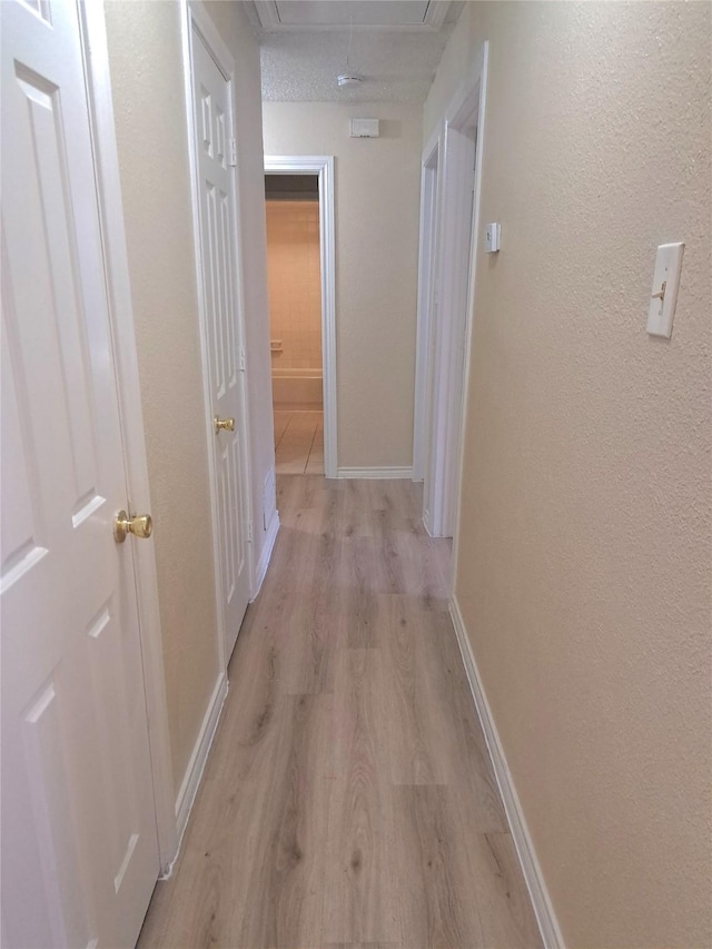 327 Trevino Trl, Lancaster, TX 75146 - corridor featuring attic access, light wood-style flooring, and baseboards