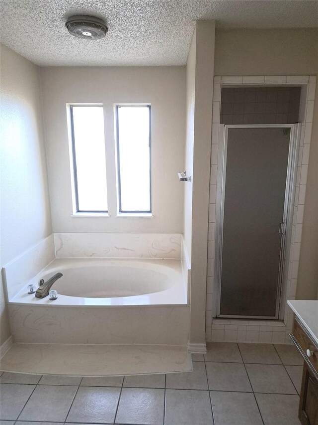 327 Trevino Trl, Lancaster, TX 75146 - bathroom with tile patterned floors, a stall shower, a bath, a textured ceiling, and vanity