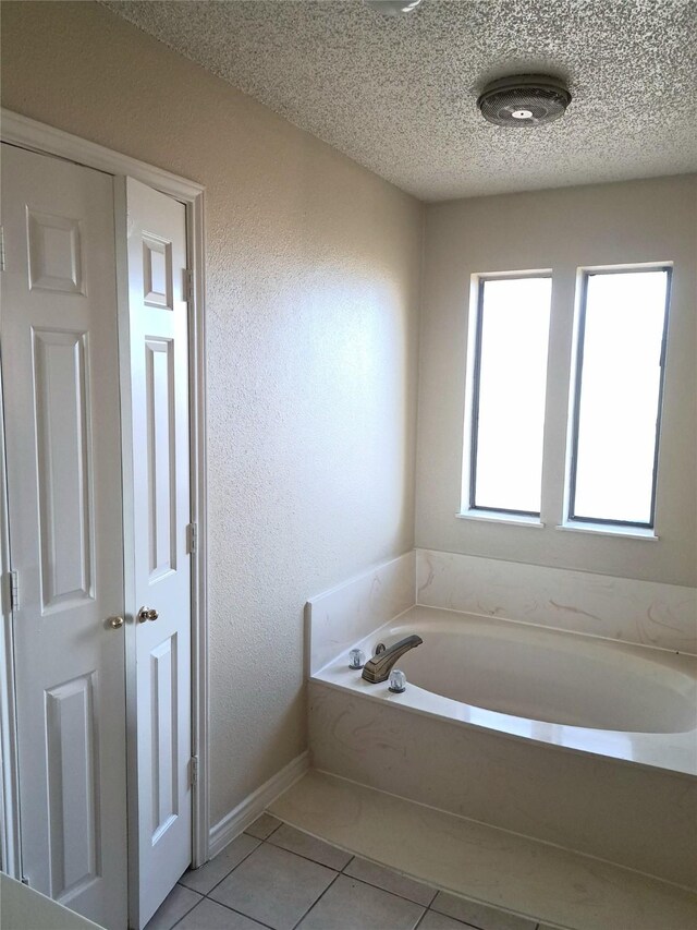 327 Trevino Trl, Lancaster, TX 75146 - full bath with tile patterned flooring, a garden tub, and a textured ceiling