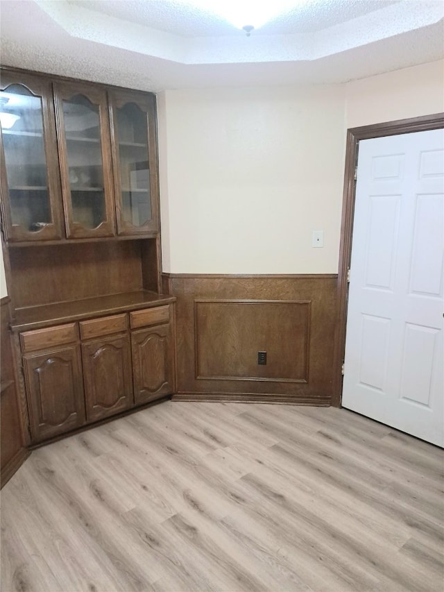 327 Trevino Trl, Lancaster, TX 75146 - unfurnished dining area with a wainscoted wall and light wood finished floors