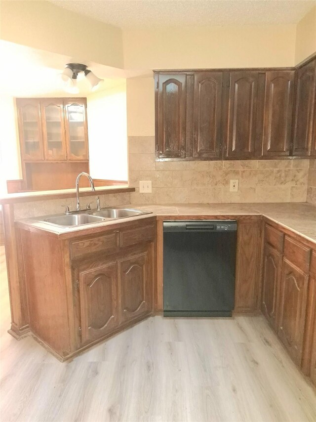 327 Trevino Trl, Lancaster, TX 75146 - kitchen featuring dishwasher, a sink, light wood-style flooring, and tasteful backsplash