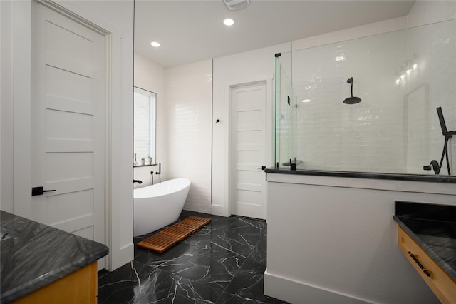 105 Shawnee Trl, Pottsboro, TX 75076 - bathroom with marble tiled floors, a walk in shower, a freestanding tub, recessed lighting, and vanity