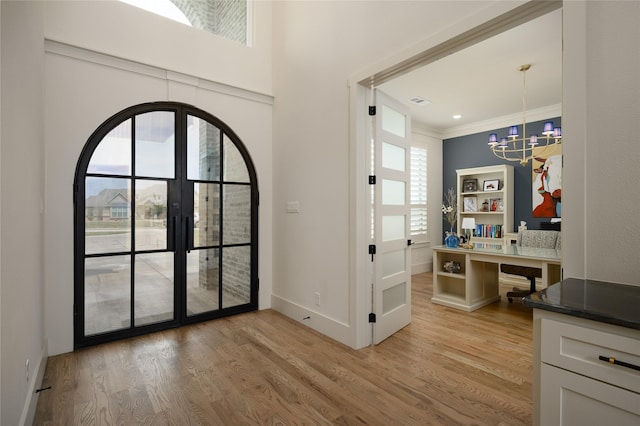 105 Shawnee Trl, Pottsboro, TX 75076 - foyer entrance featuring a chandelier, light wood-type flooring, ornamental molding, baseboards, and french doors