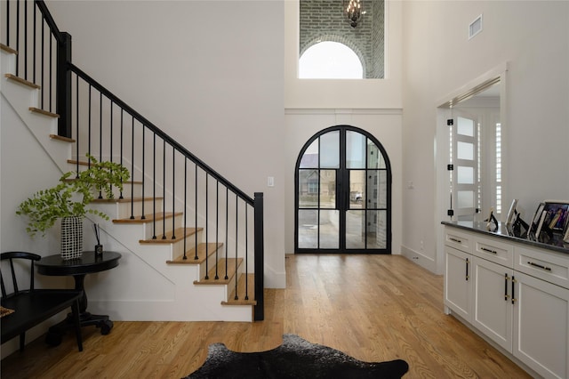 105 Shawnee Trl, Pottsboro, TX 75076 - foyer featuring a high ceiling, light wood-type flooring, stairway, baseboards, and french doors