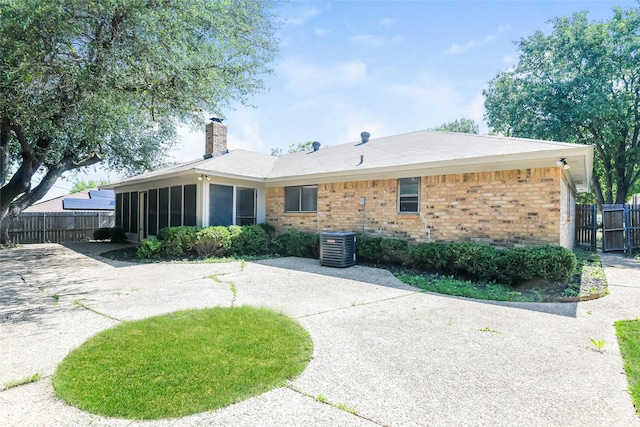 5304 Weddington Ct, Fort Worth, TX 76133 - back of property featuring brick siding, a chimney, fence, and a sunroom