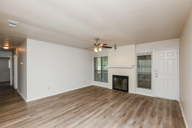 5304 Weddington Ct, Fort Worth, TX 76133 - unfurnished living room with ceiling fan, wood finished floors, baseboards, and a brick fireplace