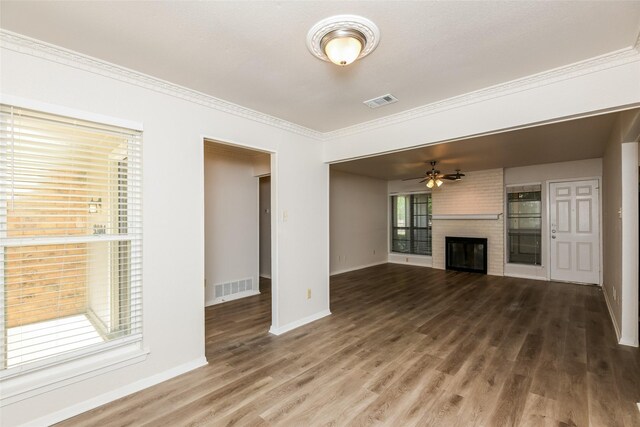 5304 Weddington Ct, Fort Worth, TX 76133 - unfurnished living room with wood finished floors, baseboards, a brick fireplace, a ceiling fan, and ornamental molding